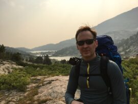 Man with backpack hiking in the mountains