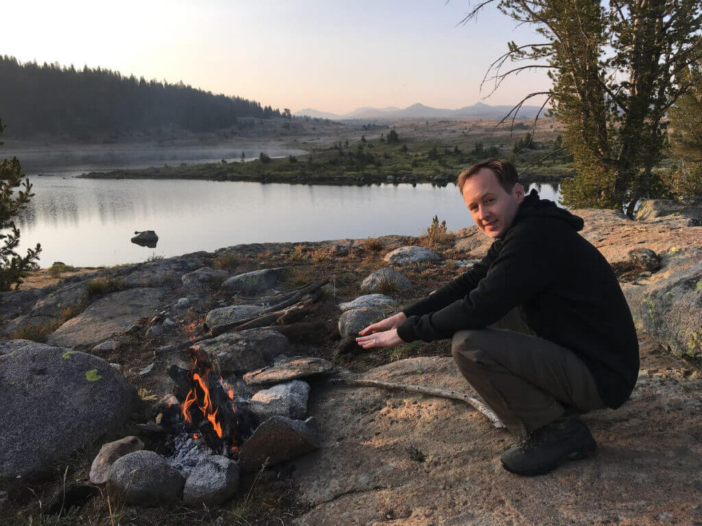 Man camping by a lake