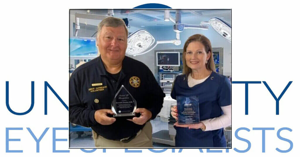 Two people holding awards